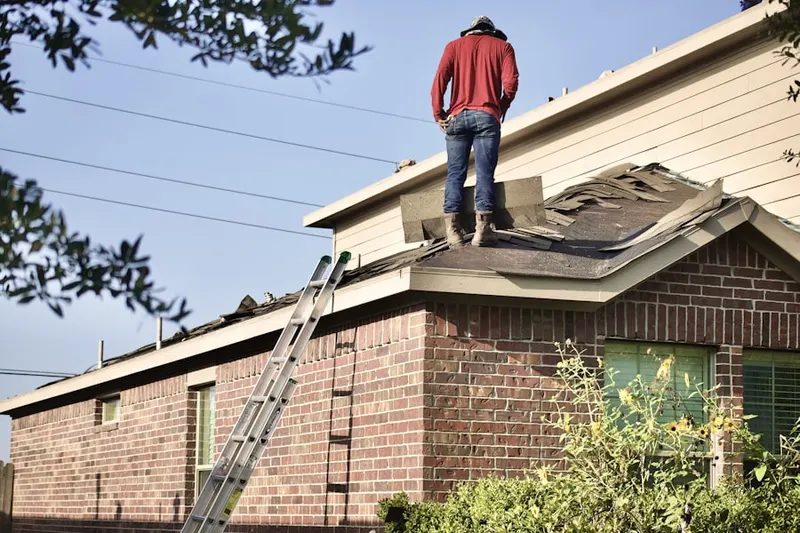 Professional roofer working on a residential roof in Spencerville